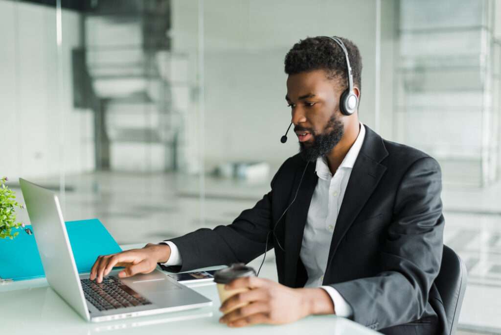 african-american-man-customer-support-operator-with-hands-free-headset-working-office